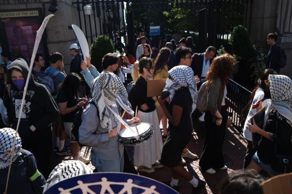 Rowdy demo<em></em>nstrators formed a picket line and banged drums as scores of students waited in lengthy lines to pass through security and gain access to Columbia's campus Tuesday. 