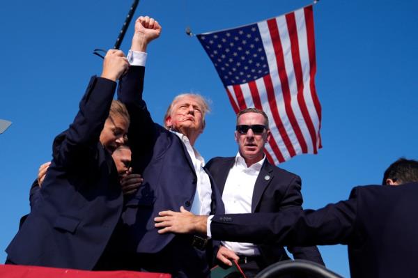 Former President Do<em></em>nald Trump, surrounded by U.S. Secret Service agents, at a campaign rally in Butler, PA, 2024