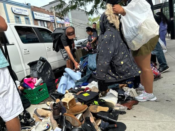 People sell goods on the sidewalk near the intersection of Roosevelt Avenue and 91st Street on Sunday, September 1, 2024 in Queens,