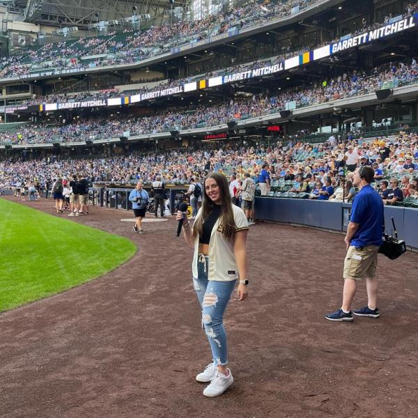 Pop singer Ali Berke standing in a ba<em></em>seball stadium ready to perform the natio<em></em>nal anthem