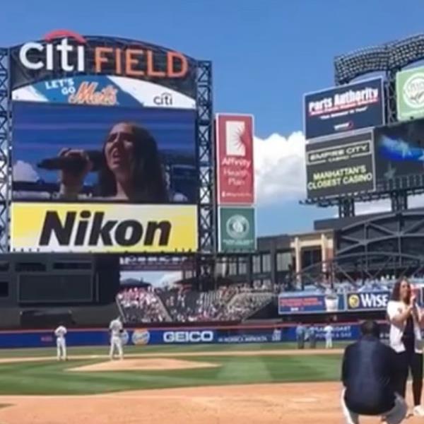 Pop singer Ali Berke performing the natio<em></em>nal anthem on a ba<em></em>seball field, aiming to set a record of singing at every Major League ba<em></em>seball stadium