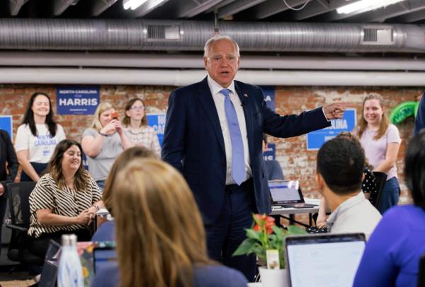 Democratic vice presidential candidate, Minnesota Gov. Tim Walz engaging in a co<em></em>nversation with volunteers at a campaign office in Raleigh, N.C. in 2024