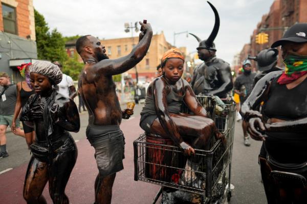 People participate in the annual J'Ouvert festival celebration on Monday, September 2, 2024 