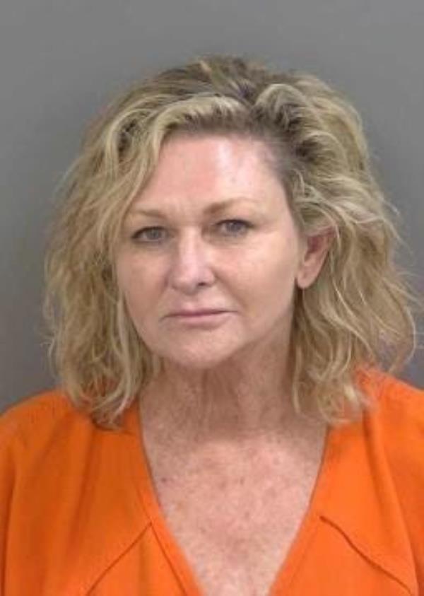 A close-up image of Naples Mayor Teresa Heitmann, showing signs of intoxication and struggling to keep her balance after failing a sobriety test.